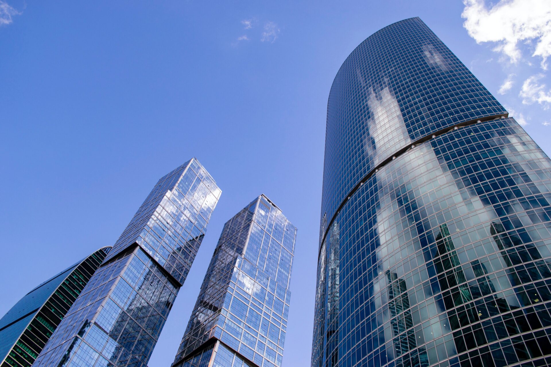 A group of tall buildings with a sky background